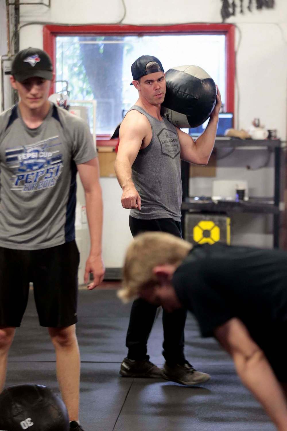 Stewart oversees Cole Younger (left) and Easton Lewicki (front right) at the Cross Fit 204 Gym. (Phil Hossack / Winnipeg Free Press)