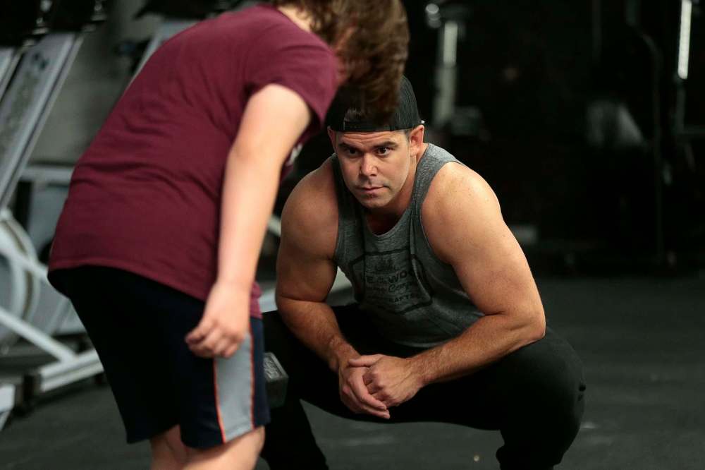 Ryan Stewart works with a young participant at Crossfit 204 gym on Berry Street. (Phil Hossack / Winnipeg Free Press)
