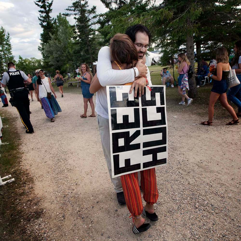 PHIL HOSSACK / WINNIPEG FREE PRESS
Folk Festival fixture and free hug vendor Greg Allan distributes his wares among folkies Friday.