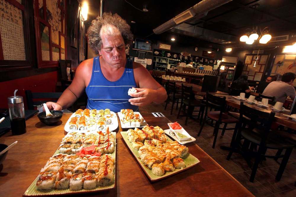 PHIL HOSSACK / WINNIPEG FREE PRESS
Professional eater John Jugovich finished off 46 perogies Friday night to win the eating contest at the Spirit of Ukraine Pavilion at Folklorama. On Saturday he was craving sushi.
