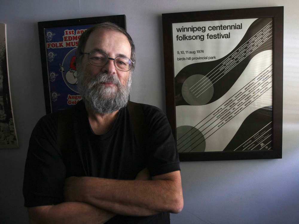 Mitch Podolak shows off the poster for the first festival that would eventually become the Winnipeg Folk Festival. (Joe Bryksa / Winnipeg Free Press)