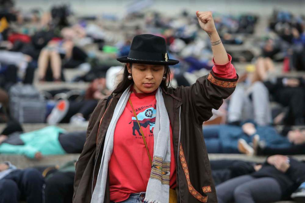 RUTH BONNEVILLE / WINNIPEG FREE PRESS
The Manitoba Youth for Climate Action holds Youth-Led Demonstration for Climate Action: Die-In at CMHR on Friday. Activist Victoria Redsun stands among the symbolically dead students in a mock demonstration symbolizing the strength of the indigenous people from the effects of climate change on the steps of the CMHR Friday.
