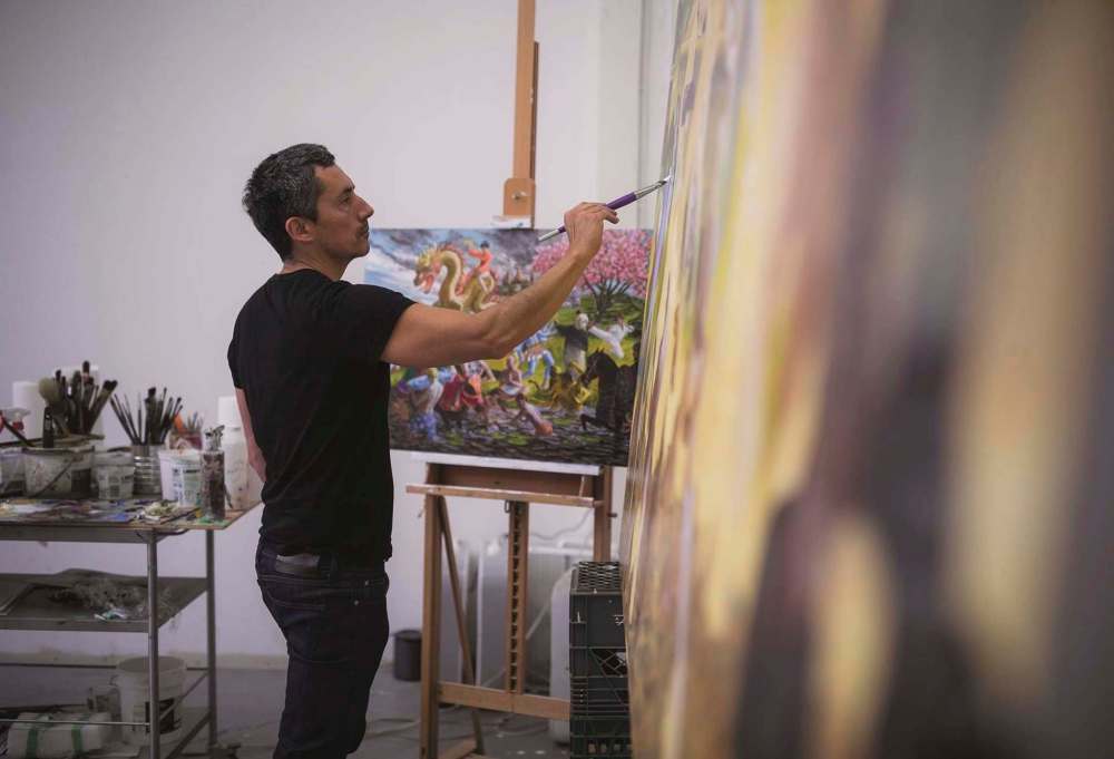 RYAN VAN DER HOUT PHOTO
Artist Kent Monkman works on a painting in his Toronto studio. His exhibition, Shame and Prejudice: A Story of Resilience, opens today at the Winnipeg Art Gallery.