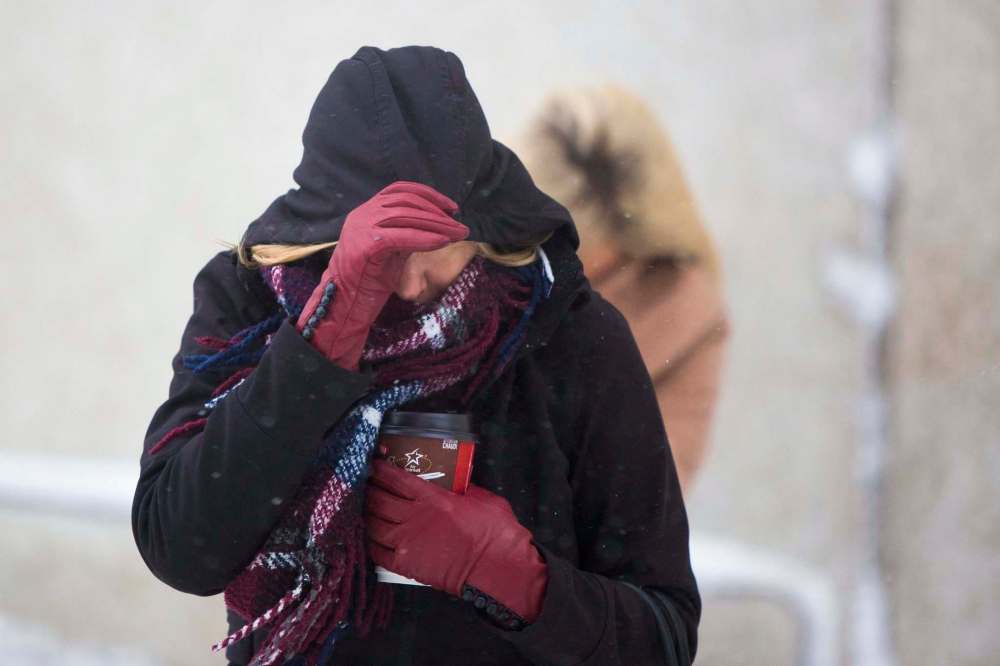 Adelma Transi battles the wind and snow in the East Exchange in Winnipeg on Friday morning. (Mikaela MacKenzie / Winnipeg Free Press)