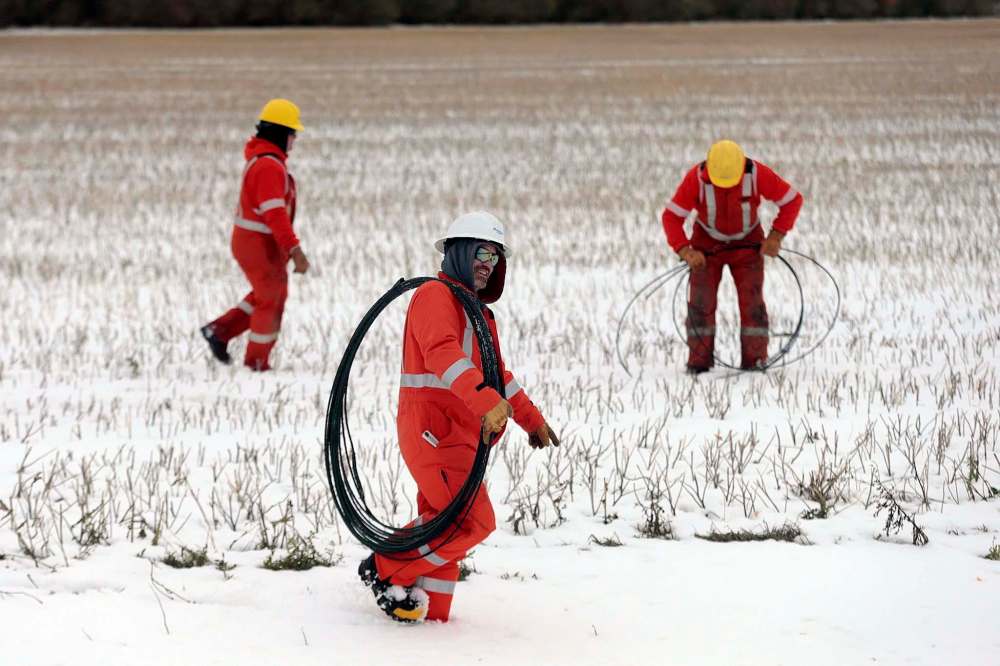 Hydro crews salvage wire in a field north of Portage Tuesday.