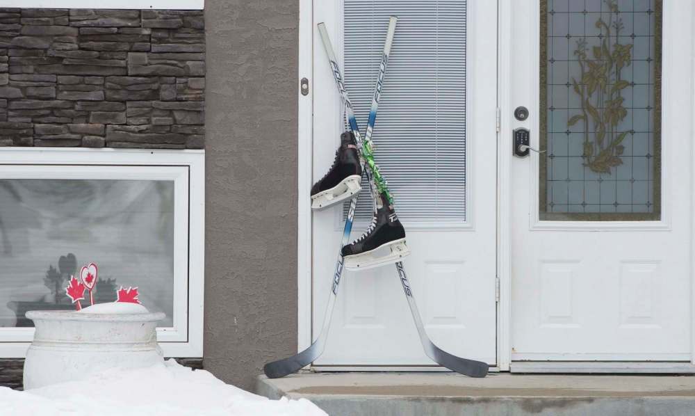 Canadians paid tribute to the Humboldt Broncos crash victims by placing hockey sticks outside their doors. (Jonathan Hayward / The Canadian Press files)