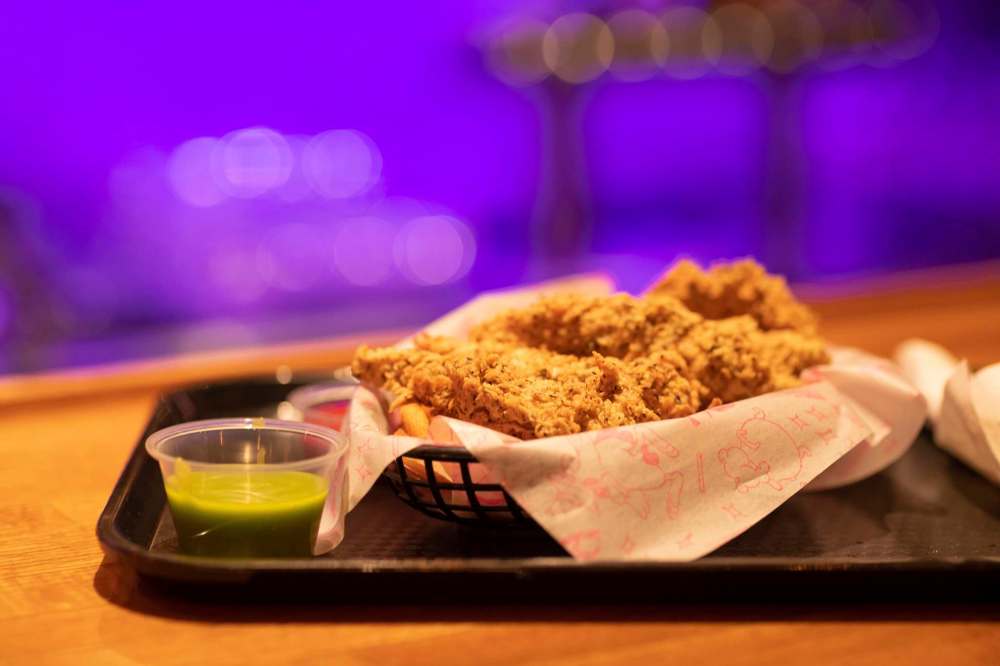 A plate of chicken fingers, curly fries, and home made honey dill sauce from Magic Bird Fried Chicken. (Mike Sudoma / Winnipeg Free Press)