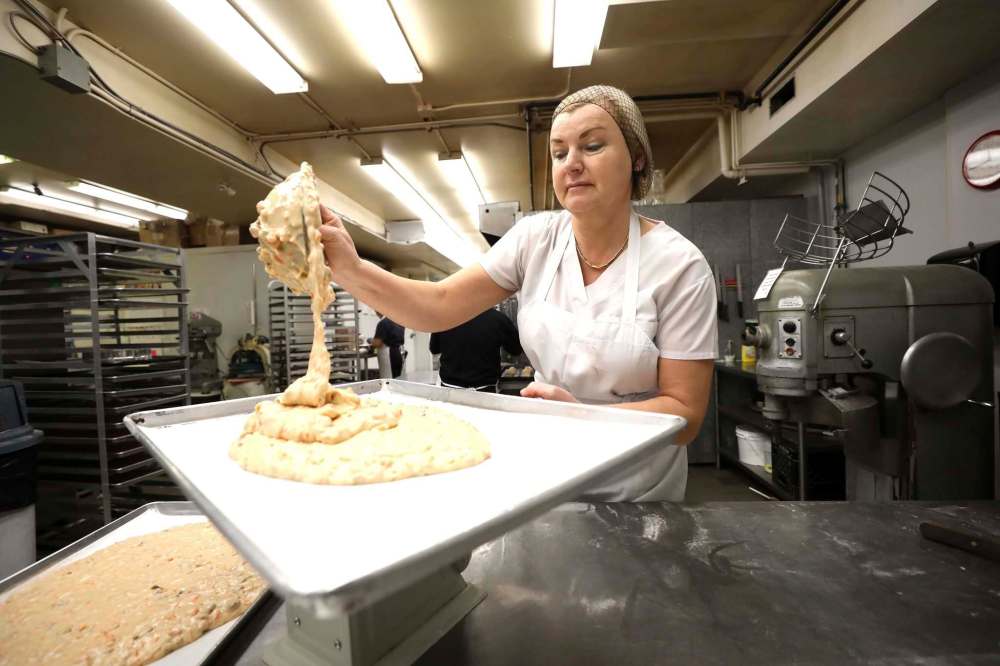 Pastry chef Elizabeth Cisma gets carrot cake batter ready for baking. (Ruth Bonneville / Winnipeg Free Press)