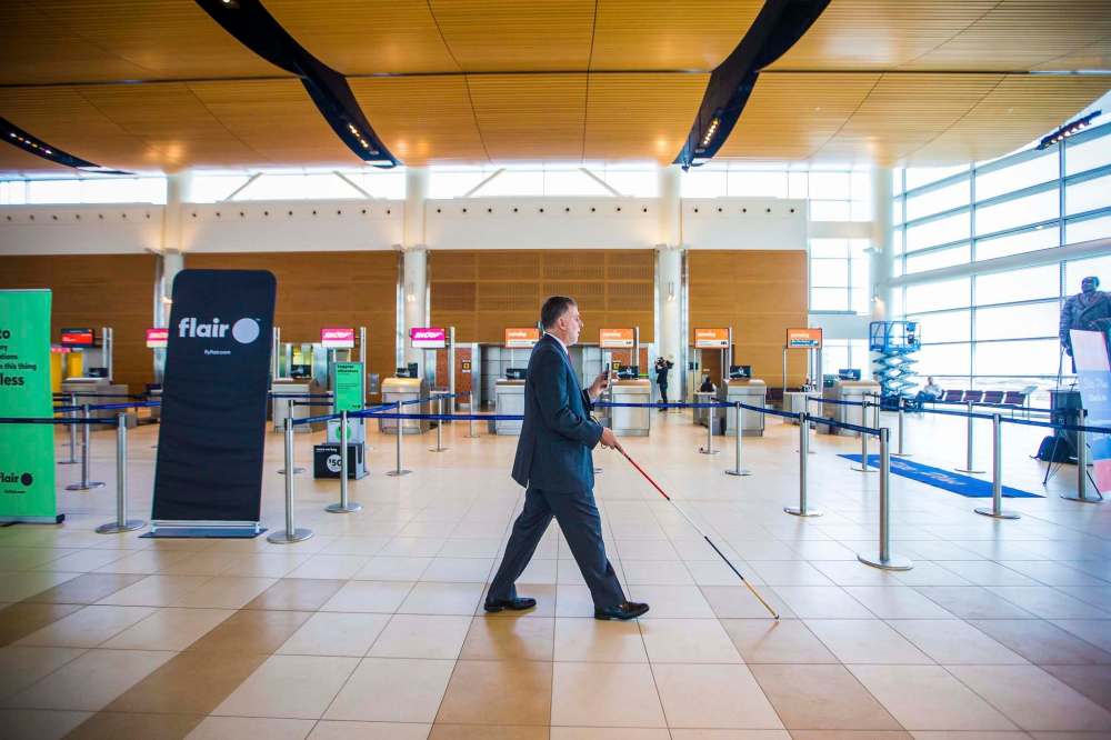 Paul Shroeder demonstrates the app at the the launch of Aira, an assistive technology service designed to help travellers who are blind navigate through the airport. (Mikaela MacKenzie / Winnipeg Free Press)