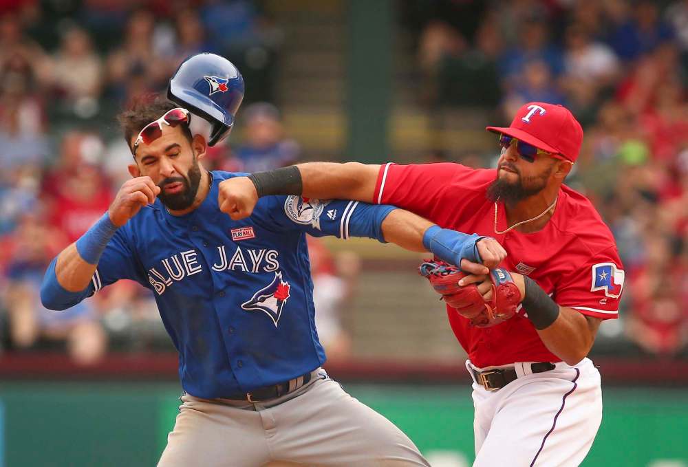 RICHARD W. RODRIGUEZ / FORT WORTH STAR-TELEGRAM / TNS
Toronto Blue Jays Jose Bautista (19) gets hit by Texas Rangers second baseman Rougned Odor (12) after Bautista slid into second in the 8th inning at Globe Life Park on May 15, 2016 in Arlington, Texas.