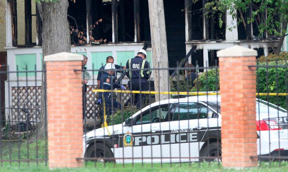 JOE BRYKSA / WINNIPEG FREE PRESS
Police have a large perimeter set up around the scene of a fatal house fire in the 100 block of Austin Street North as fire officials investigate.