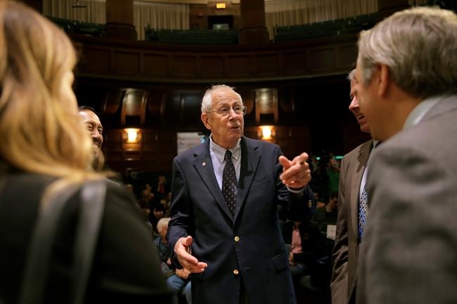 James Peebles, a 2019 Nobel laureate in physics, speaks with people before the start of a news conference at Princeton University in Princeton, N.J., Tuesday, Oct. 8, 2019. Peebles, an emeritus professor at Princeton University, shares the Nobel prize with Swiss scientists Michel Mayor and Didier Queloz for their work in understanding how the universe has evolved from the Big Bang and the blockbuster discovery of the first known planet outside our solar system. (AP Photo/Seth Wenig)