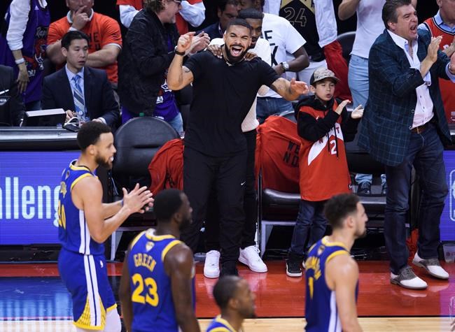 Rapper Drake yells at Golden State Warriors players while playing against the Toronto Raptors during first half Game 5 NBA Finals basketball action in Toronto on Monday, June 10, 2019. THE CANADIAN PRESS/Nathan Denette