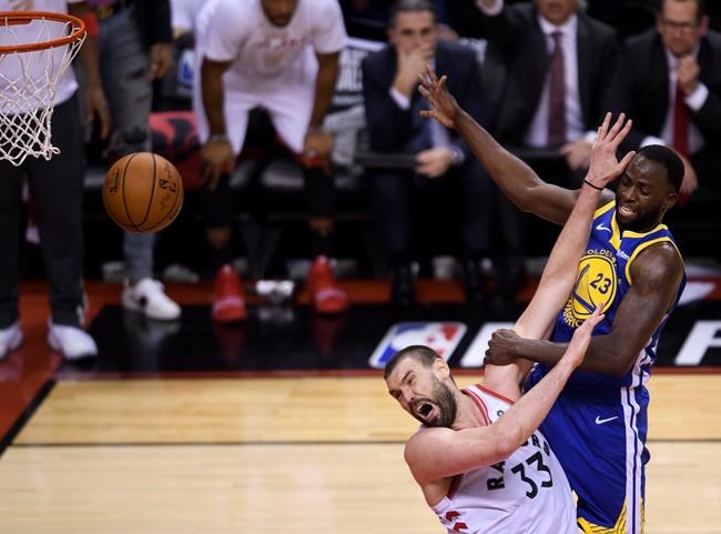 Toronto Raptors centre Marc Gasol (33) fouls Golden State Warriors forward Draymond Green (23) during second half Game 5 NBA Finals basketball action in Toronto on Monday, June 10, 2019. THE CANADIAN PRESS/Nathan Denette