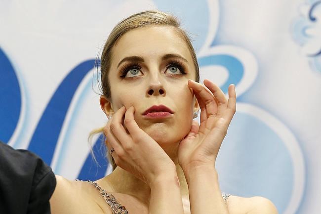 FILE - In this Jan. 5, 2018, file photo, Ashley Wagner waits for her scores during the women's free skate event at the U.S. Figure Skating Championships in San Jose, Calif. Former Olympian Ashley Wagner says she was sexually assaulted by another figure skater in 2008 when she 17. The three-time national champion writes in USA Today on Thursday, Aug. 1, 2019, that John Coughlin climbed into her bed after a party at a skating camp and began kissing and groping her. Coughlin was 22 at the time and took his life in January at 33. Wagner says she was