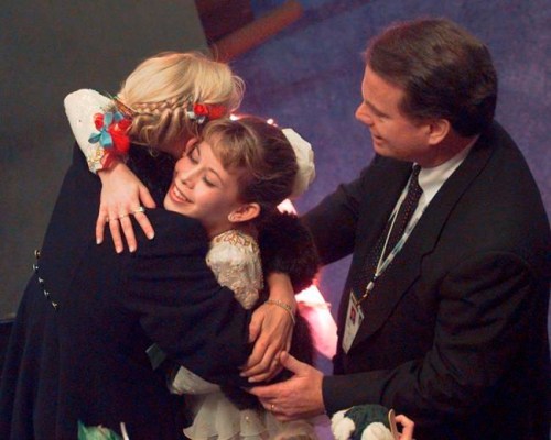 FILE - In this Saturday, Feb. 15, 1997 file photo, figure skater Tara Lipinski with her coach Richard Callaghan receives a hug after it was announced she won the gold medal at the U.S. Figure Skating Championships in Nashville, Tenn. Richard Callaghan, who coached Tara Lipinski to Olympic gold, has been banned from figure skating by the U.S. Center for SafeSport for sexual misconduct. (AP Photo/Cliff Schiappa, File)