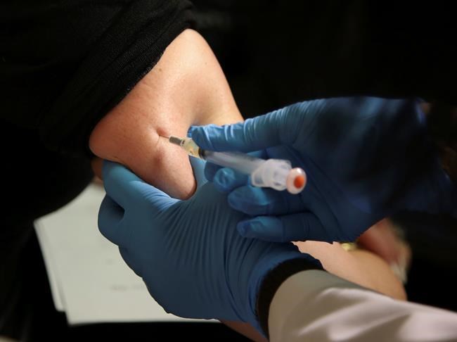 FILE - In this March 27, 2019, file photo, a woman receives a measles, mumps and rubella vaccine at the Rockland County Health Department in Pomona, N.Y. Measles cases in the U.S. this year have climbed to the highest level in 25 years, according to preliminary figures, a resurgence attributed largely to misinformation about vaccines. (AP Photo/Seth Wenig, File)