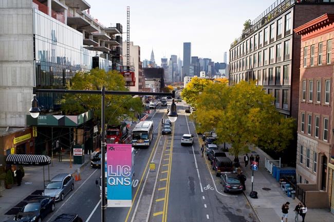 FILE- In this Nov. 7, 2018, file photo traffic moves along 44th Drive in Long Island City in the Queens borough of New York. According to experts analyzing the e-commerce giant's sudden cancellation of plans to build a massive headquarters in New York City, Amazon's decision to walk away could scare off other tech companies considering moving to or expanding in the city. (AP Photo/Mark Lennihan, File)