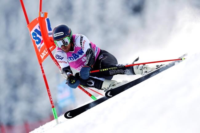 FILE- In this Jan. 12, 2019, file photo, Ted Ligety, of the United States, competes during a ski World Cup men's Giant Slalom in Adelboden, Switzerland. The 35-year-old American has decided to reduce his workload this season and will only race in giant slalom.(AP Photo/Shinichiro Tanaka, File)