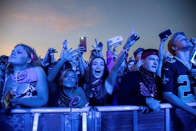 FILE - In this Sunday, Oct. 27, 2019, file photo, festival-goers attend the Voodoo Music Experience in City Park in New Orleans. Major concert promoters in the U.S. are stepping back from plans to scan festival-goers with facial recognition technology, at least for the time being. (Photo by Amy Harris/Invision/AP, File)