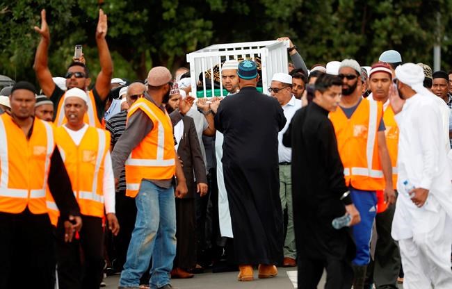 Mourners carry the body of Imam Hafiz Musa Patel, a victim of the Friday March 15 mosque shootings in Christchurch at the Puhinui Memorial Gardens in Auckland, New Zealand, Thursday, March 21, 2019. (Dean Purcell/New Zealand Herald via AP)
