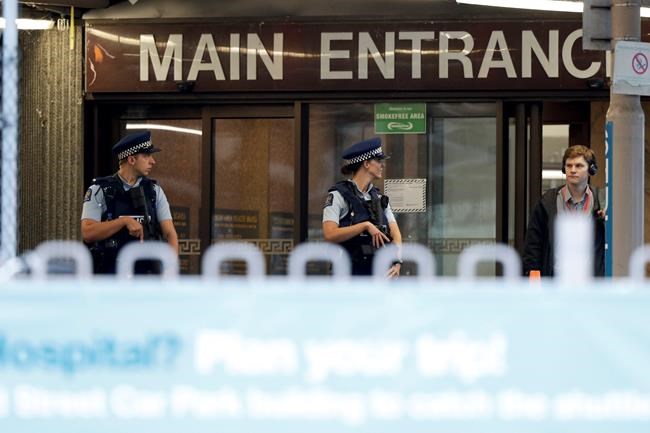 Police stand guard at Christchurch Hospital, which is under lockdown, after mass shootings at two mosques in Christchurch, New Zealand, Saturday, March 16, 2019. (AP Photo/Mark Baker)