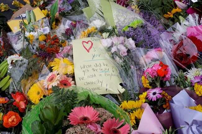 A handwritten message is placed at a makeshift memorial near the Masjid Al Noor mosque in Christchurch, New Zealand, Saturday, March 16, 2019, where one of the two mosque mass shootings at occurred. (AP Photo/Mark Baker)