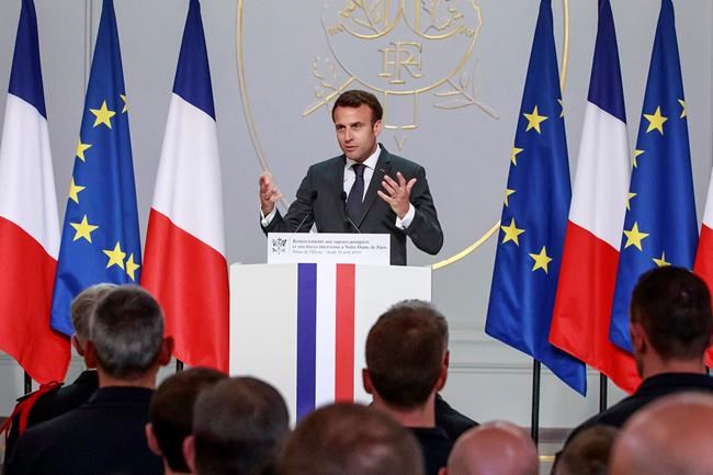 French President Emmanuel Macron addresses Paris Firefighters' brigade and security forces who took part at the fire extinguishing operations of the Notre Dame of Paris Cathedral fire, at the Elysee Palace in Paris, Thursday, April 18, 2019. France paid a daylong tribute Thursday to the Paris firefighters who saved the internationally revered Notre Dame Cathedral from collapse and rescued many of its treasures.(Christophe Petit Tesson, Pool via AP)