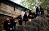 People stand to watch and photograph the Notre Dame cathedral after the fire in Paris, Tuesday, April 16, 2019. Experts are assessing the blackened shell of Paris' iconic Notre Dame cathedral to establish next steps to save what remains after a devastating fire destroyed much of the almost 900-year-old building. With the fire that broke out Monday evening and quickly consumed the cathedral now under control, attention is turning to ensuring the structural integrity of the remaining building. (AP Photo/Kamil Zihnioglu)