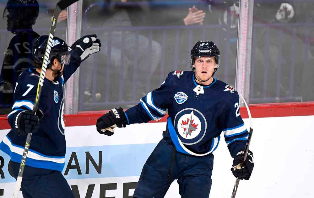 Nikolaj Ehlers (right) celebrates the Jets' first goal Friday with Ben Chiarot. (Martti Kainulainen / Lehtikuva)