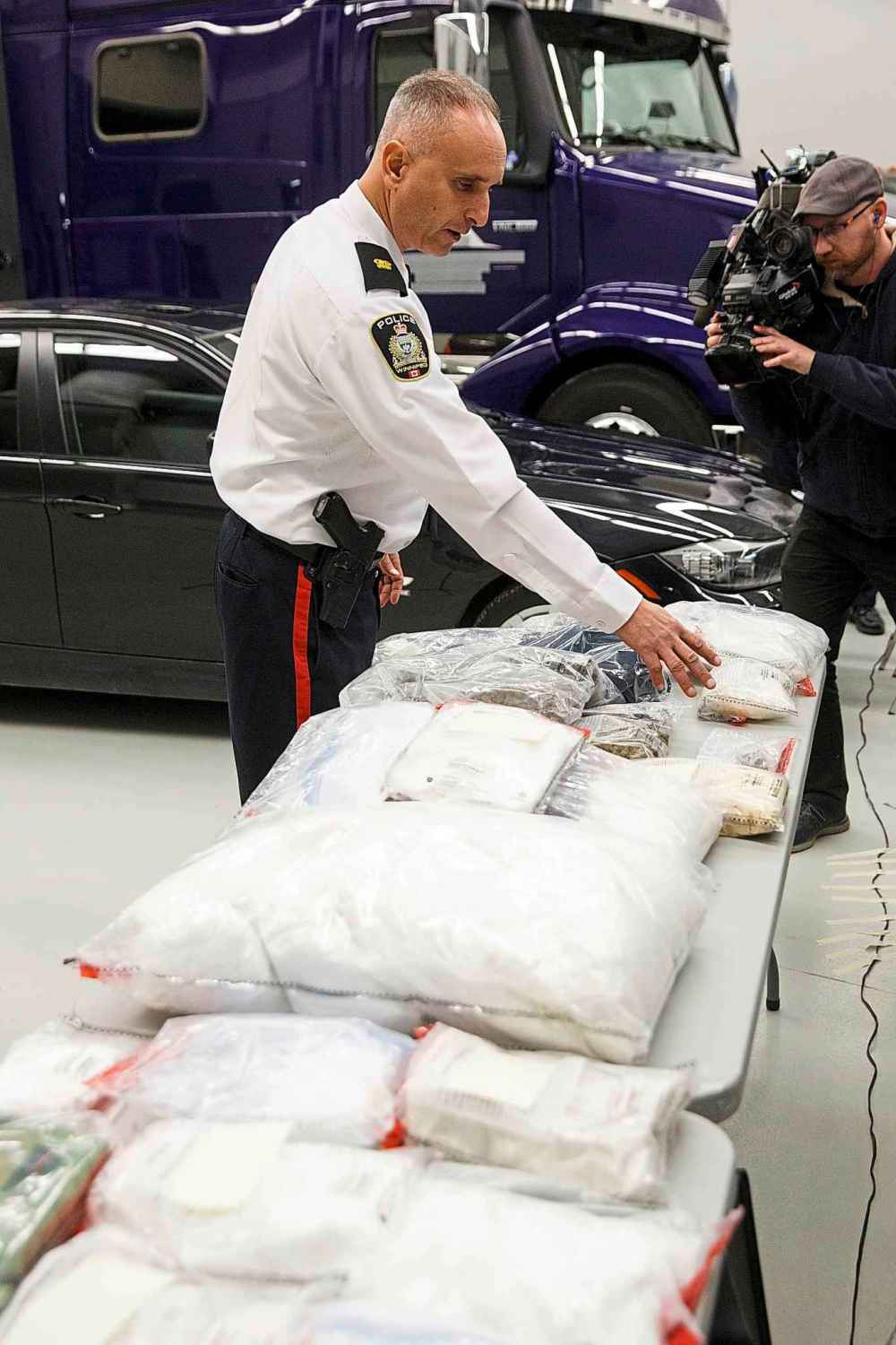 MIKE DEAL / WINNIPEG FREE PRESS
Winnipeg police Inspector Max Waddell inspects some of the contraband seized in the raid.