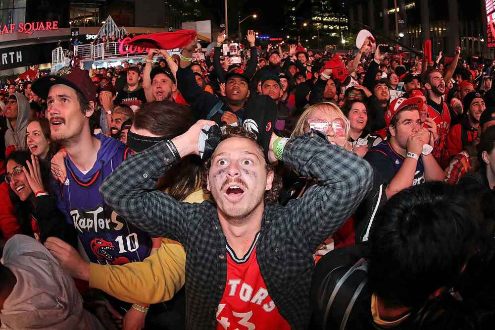 (Tom Szczerbowski/Getty Images/TNS)
Raptors fans watch the closing moments of the fourth quarter as they gather at Jurassic Park to watch the Golden State Warriors play against the Toronto Raptors during Game Five of the 2019 NBA Finals at Scotiabank Arena on Monday in Toronto.