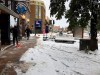 People clear the sidewalk after a fall snowstorm in Helena, Mont., on Wednesday, Oct. 9, 2019. The central Rocky Mountain region recieved its first dose of wintry weather. Mountainous areas recently hit by snowfall measured in feet (meters) could get another foot (30 centimeters) or more by Thursday. (AP Photo/Matt Volz)