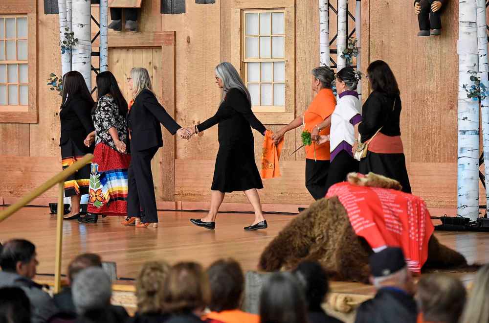 Justin Tang / The Canadian Press
A ceremonial cloth with the names of 2,800 children who died in residential schools and were identified in the National Student Memorial Register, lies on a bear skin as grandmothers and bearers of the ceremonial cloth walk off stage together during the Honouring National Day for Truth and Reconciliation ceremony in Gatineau, Quebec on Monday, Sept. 30, 2019.