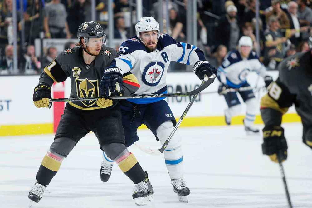 MIKAELA MACKENZIE / WINNIPEG FREE PRESS
Knights forward Cody Eakin and Jets forward Mark Scheifele battle for position in the third period.