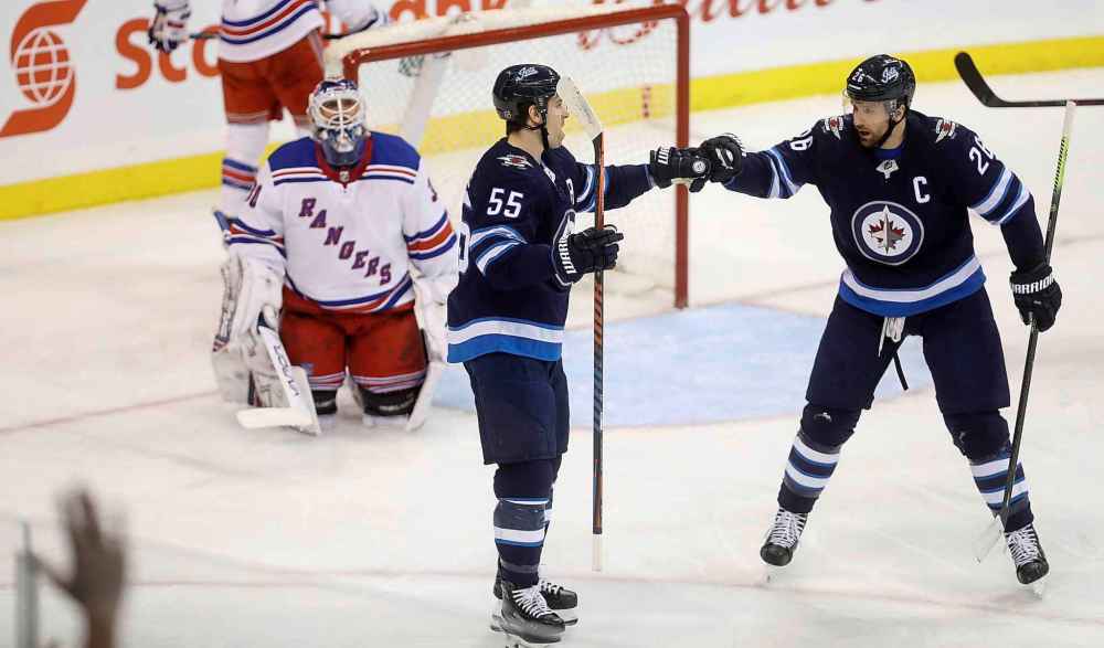 Trevor Hagan / THE CANADIAN PRESS FILES
Scheifele, left, with linemate, right wing Blake Wheeler. Wheeler's five-year contract extension will kick in next season, paying him $8.25 million a year and pushing Scheifele even further down the list of top salaries on the Jets.