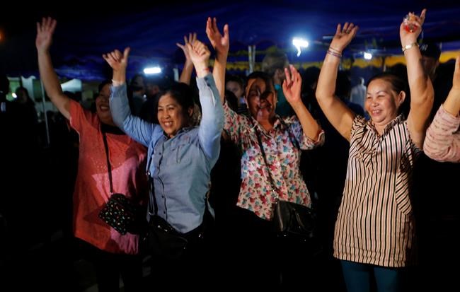 Peoples celebrate after evacuation in Chiang Rai as divers evacuated some of the 12 boys and their coach trapped at Tham Luang cave in the Mae Sai district of Chiang Rai province, northern Thailand, Tuesday, July 10, 2018. Thai Navy SEALs say all 12 boys and their coach were rescued from the cave, ending an ordeal that lasted more than 2 weeks. (AP Photo/Sakchai Lalit)