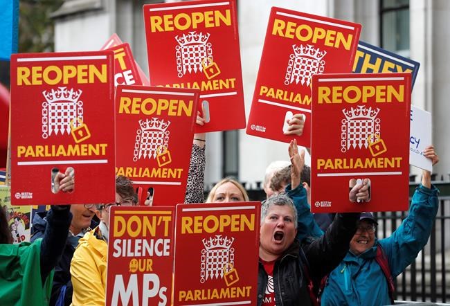 Anti-Brexit supporters react as they gather outside the Supreme Court in London, Tuesday, Sept. 24, 2019 as it made it's decision on the legality of Prime Minister Boris Johnson's five-week suspension of Parliament. In a setback for Johnson, Britain's Supreme Court has ruled that the suspension of Parliament was illegal. The ruling Tuesday is a major blow to the prime minister who had suspended Parliament for five weeks, claiming it was a routine closure. (AP Photo/Frank Augstein)