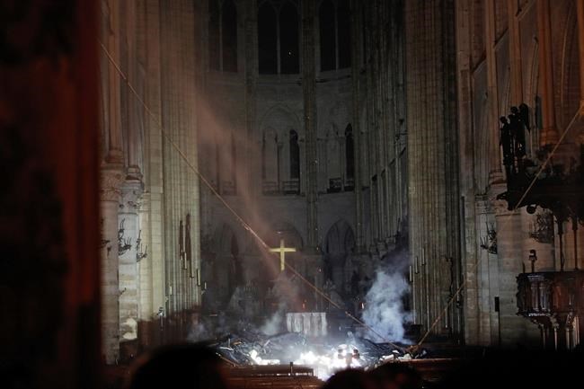 Smoke is seen in the interior of Notre Dame cathedral in Paris, Monday, April 15, 2019. A catastrophic fire engulfed the upper reaches of Paris' soaring Notre Dame Cathedral as it was undergoing renovations Monday, threatening one of the greatest architectural treasures of the Western world as tourists and Parisians looked on aghast from the streets below. (Philippe Wojazer/Pool via AP)