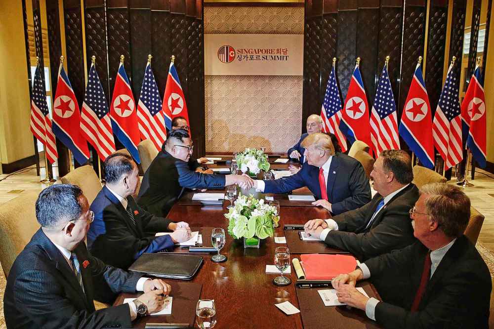 North Korea's Kim Jong Un, third from left, shakes hands with U.S. President Donald Trump, third from right, in Singapore. (Kevin Lim/The Straits Times/Zuma Press/TNS)