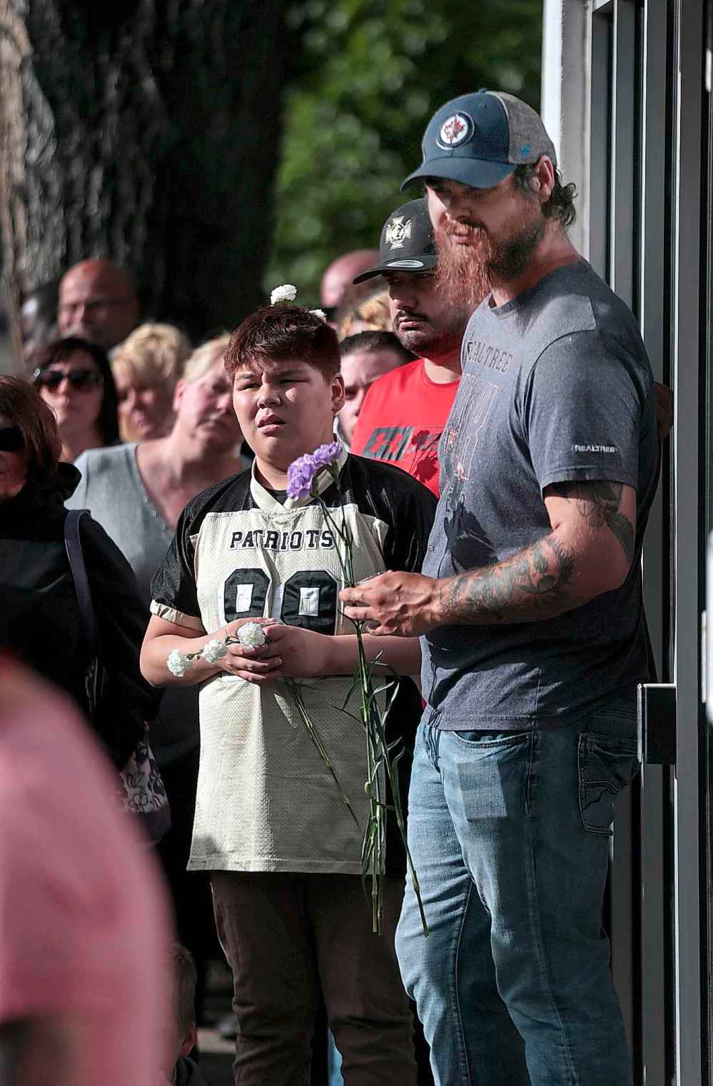 PHIL HOSSACK / WINNIPEG FREE PRESS
Some of the people gathered at a vigil held at Sherbrook to remember the father, brother, son and football coach they lost to a random, fatal stabbing.