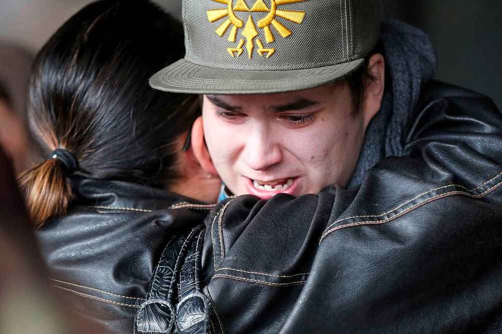 JOHN WOODS / THE CANADIAN PRESS
Doyle Straight Jr. (Hunter's dad) is comforted at the vigil.