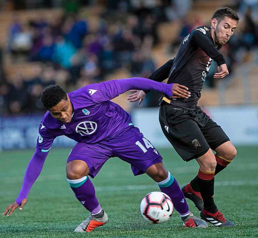 DARREN STONE / TIMES COLONIST
Pacific FC's Terran Campbell and Valour FC's Louis Béland-Goyette look for a loose ball in CPL action at Westhills Stadium in Victoria, B.C., Wednesday.