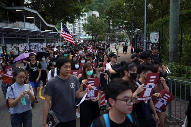 Students march to the Chinese University to show support to those students who were arrested by police in Hong Kong, Thursday, Oct.3, 2019. (AP Photo/Vincent Thian)