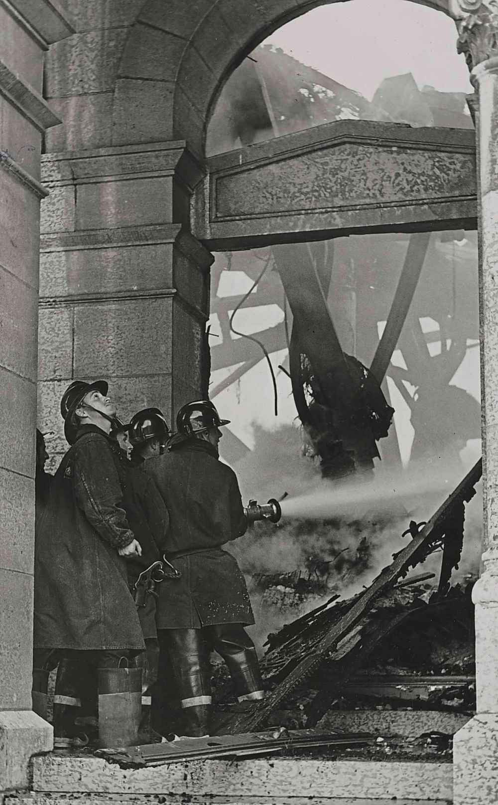 Firefighters train a hose on the interior of the basilica in an effort to save part of the building from the flames. (Winnipeg Free Press files)