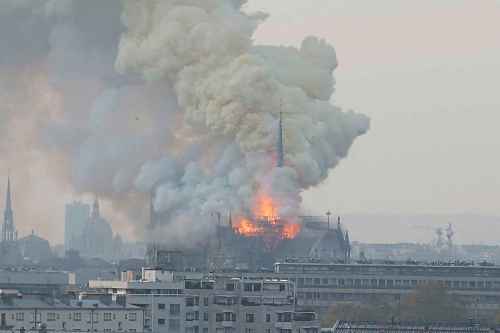 Tribune Media TNS
Smoke and flames rise during a fire at the landmark Notre Dame Cathedral in central Paris, France on Monday. (Jerome Domine/Abaca Press/TNS)