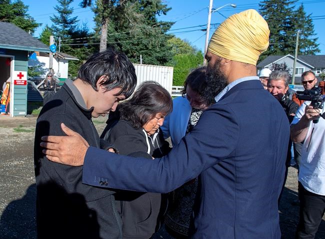 NDP Leader Jagmeet Singh talks with Betty Nicolaye and one of her three children as he makes a campaign stop with Rachel Blaney, NDP Candidate for North Island-Powell River, at a Habitat for Humanity project in Campbell River, B.C. on Thursday, Sept. 26, 2019. The family is homeless and living in their van. THE CANADIAN PRESS/Andrew Vaughan
