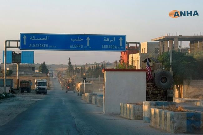In this image provided by Hawar News Agency, ANHA, a line of U.S. military vehicles travel down a main road in northeast Syria, Monday, Oct. 7, 2019. U.S.-backed Kurdish-led forces in Syria said American troops began withdrawing Monday from their positions along Turkey's border in northeastern Syria, ahead of an anticipated Turkish invasion that the Kurds say will overturn five years of achievements in the battle against the Islamic State group. (ANHA via AP)