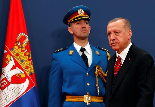 Turkey's President Recep Tayyip Erdogan, right, arrives at a joint news conference after talks with his Serbian counterpart Aleksandar Vucic, in Belgrade, Serbia, Monday, Oct. 7, 2019. Erdogan is on a two-day official visit to Serbia. (AP Photo/Darko Vojinovic)