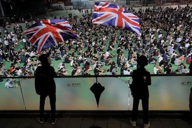 Residents gather to protest a teenage demonstrator shot at close range in the chest by a police officer and condemn police tactics and demand accountability, in Hong Kong, Wednesday, Oct. 2, 2019. The shooting Tuesday during widespread anti-government demonstrations on China's National Day was a fearsome escalation in Hong Kong's protest violence. The 18-year-old is the first known victim of police gunfire since the protests began in June. He was hospitalized and his condition was described by the government as stable on Wednesday. (AP Photo/Kin Cheung)